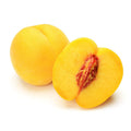 Yellow peaches, one halved showing red pit and fuzzy yellow flesh