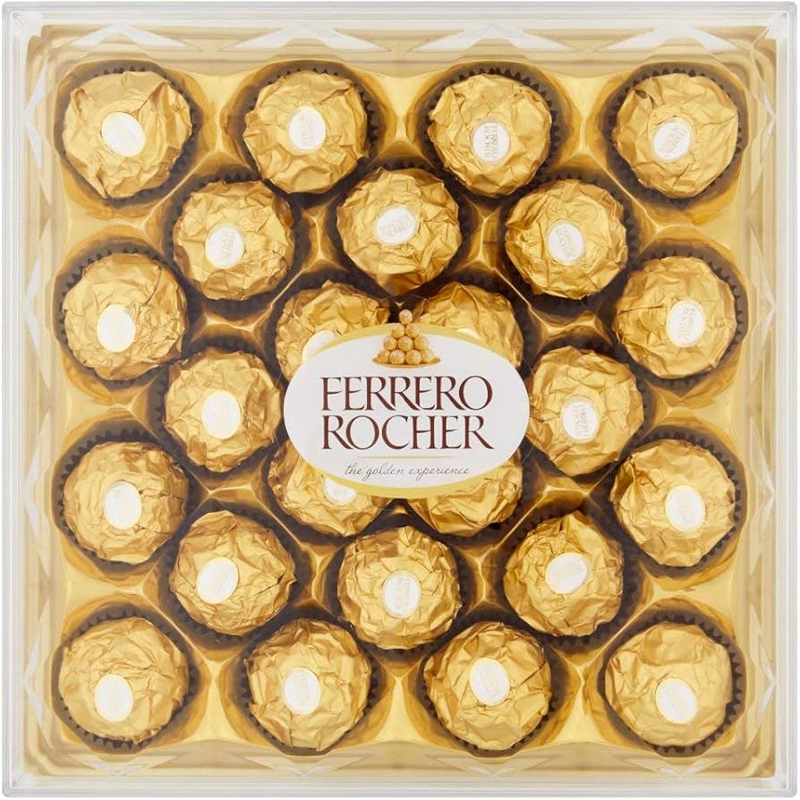 Ferrero Rocher chocolates in a clear tray, round gold-wrapped pieces with white centers
