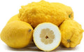 Yellow lemon fruit cluster with one lemon half showing seeds and pale pulp