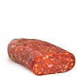 Spianata piccante sausage, reddish cured cylinder with speckled texture